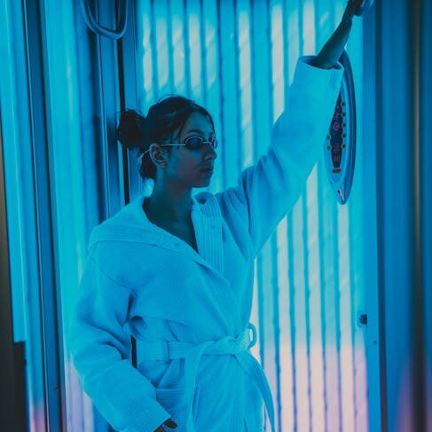 Woman Posing in Solarium in Bathrobe